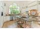 Spacious kitchen with granite island, stainless steel appliances, and a large arched window overlooking backyard at 2516 Selwyn Ave, Charlotte, NC 28209