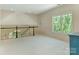Open loft area with a large window and railing overlooking lower level at 2516 Selwyn Ave, Charlotte, NC 28209