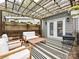 Inviting back deck features comfortable furniture and stylish outdoor rug at 2518 Pinckney Ave, Charlotte, NC 28205
