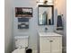 Bathroom with white vanity, framed painting, towels, modern mirror and single sink at 2518 Pinckney Ave, Charlotte, NC 28205