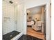 Modern bathroom with glass shower and a view into bedroom; features hexagon tile flooring and white subway tile at 2518 Pinckney Ave, Charlotte, NC 28205