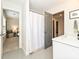 Bright bathroom features a shower with curtain and white vanity with modern fixtures at 2518 Pinckney Ave, Charlotte, NC 28205