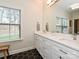 Well-lit bathroom featuring a large vanity with double sinks, hexagon tile flooring, and bright natural lighting at 2518 Pinckney Ave, Charlotte, NC 28205