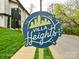 Villa Heights community sign showing nearby home with green lawn and beautiful foliage, promoting the neighborhood amenities at 2518 Pinckney Ave, Charlotte, NC 28205