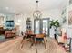 Dining area with a round wooden table, modern lighting fixture, and view to living room at 2518 Pinckney Ave, Charlotte, NC 28205