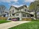 Charming two-story home with light green siding, black shutters, a well-manicured lawn, and blossoming landscaping at 2518 Pinckney Ave, Charlotte, NC 28205