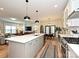 Open-concept kitchen flows into the living and dining areas with a large island and stainless steel appliances at 2518 Pinckney Ave, Charlotte, NC 28205