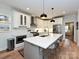 Bright kitchen features a large island with a sink, stainless steel appliances, and pendant lighting at 2518 Pinckney Ave, Charlotte, NC 28205