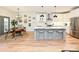 Bright and modern kitchen featuring stainless steel appliances, a center island with seating, and hardwood floors at 2518 Pinckney Ave, Charlotte, NC 28205