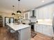This modern kitchen features an island with seating, stainless steel appliances, and stylish lighting at 2518 Pinckney Ave, Charlotte, NC 28205