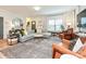 Comfortable living room featuring hardwood floors, neutral furniture, a large window, and a classic area rug at 2518 Pinckney Ave, Charlotte, NC 28205