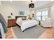 Main bedroom features a comfortable bed, soft lighting, and a cozy sitting area at 2518 Pinckney Ave, Charlotte, NC 28205