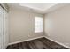 A bright bedroom with closet, window, and modern wood look flooring at 2599 April Showers Ln, Rock Hill, SC 29730