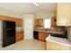 Kitchen featuring wood cabinets, black appliances, tile floor, and mosaic backsplash at 2599 April Showers Ln, Rock Hill, SC 29730