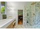 Stylish bathroom boasting marble shower, double sink vanity with marble countertop and modern fixtures at 2600 Cloister Dr, Charlotte, NC 28211