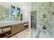 Modern bathroom featuring marble floors, a glass-enclosed shower, and a double vanity at 2600 Cloister Dr, Charlotte, NC 28211