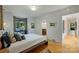 Cozy bedroom with hardwood floors, a comfortable bed, and a view of the en-suite bathroom at 2600 Cloister Dr, Charlotte, NC 28211