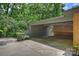Attached carport with storage sheds and unique brick accent wall at 2600 Cloister Dr, Charlotte, NC 28211