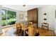 Dining room with wood floors, modern light fixture, and views of the outdoors at 2600 Cloister Dr, Charlotte, NC 28211