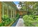 Brick home with large windows and lush landscaping along the pathway at 2600 Cloister Dr, Charlotte, NC 28211