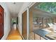 Bright hallway with hardwood floors, glass walls, and a view of the outside patio at 2600 Cloister Dr, Charlotte, NC 28211