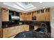 Stylish kitchen featuring modern appliances, dark countertops, and a skylight at 2600 Cloister Dr, Charlotte, NC 28211