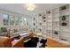 Bright living room with a large bookcase, hardwood floors and modern furniture at 2600 Cloister Dr, Charlotte, NC 28211