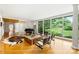 Bright living room features hardwood floors, floor-to-ceiling windows, and stylish mid-century modern decor at 2600 Cloister Dr, Charlotte, NC 28211
