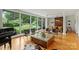 Spacious living room filled with natural light from large windows, hardwood floors, and elegant furniture at 2600 Cloister Dr, Charlotte, NC 28211