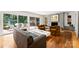 Bright living room with hardwood floors, brick fireplace, and access to an outdoor patio at 2600 Cloister Dr, Charlotte, NC 28211
