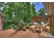 Brick patio with outdoor dining set, grill, and views of the lush backyard at 2600 Cloister Dr, Charlotte, NC 28211