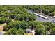 Expansive aerial shot showcasing a lakeside home nestled in lush greenery near the community marina at 29049 Snapper Pt, Tega Cay, SC 29708