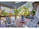 Spacious covered wooden back deck providing picturesque views of a lush tree lined lake at 29049 Snapper Pt, Tega Cay, SC 29708