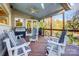 Spacious covered wooden back deck featuring patio seating, a grill, and views of nature at 29049 Snapper Pt, Tega Cay, SC 29708