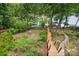 Elevated view of the backyard featuring stairs leading down to a lake and personal boat dock at 29049 Snapper Pt, Tega Cay, SC 29708
