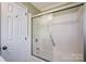 A bathroom featuring a shower with sliding glass door, a toilet, and neutral walls at 29049 Snapper Pt, Tega Cay, SC 29708