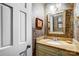 This bathroom includes a vanity with framed mirror and custom wallpaper at 29049 Snapper Pt, Tega Cay, SC 29708