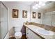 Neutral bathroom featuring a vanity with framed art and a glass-enclosed shower at 29049 Snapper Pt, Tega Cay, SC 29708