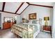 Vaulted ceiling bedroom featuring neutral walls and a large brass bed at 29049 Snapper Pt, Tega Cay, SC 29708