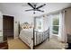 Comfortable bedroom featuring natural light from two windows and a decorative wrought iron bed frame at 29049 Snapper Pt, Tega Cay, SC 29708
