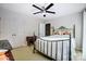 Bedroom with a black ceiling fan, and a decorative wrought iron bed frame plus a double-door closet at 29049 Snapper Pt, Tega Cay, SC 29708