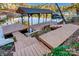Lakefront boat dock with covered boat slip and seating area for enjoying waterfront views at 29049 Snapper Pt, Tega Cay, SC 29708