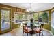 Sunny breakfast nook features a glass table, bright windows, and a door to the deck at 29049 Snapper Pt, Tega Cay, SC 29708