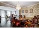 Dining room features a crystal chandelier, patterned wallpaper, hardwood floors, and traditional-style furniture at 29049 Snapper Pt, Tega Cay, SC 29708