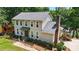 Charming two-story home featuring a brick chimney, well-manicured bushes, and lush green lawn at 29049 Snapper Pt, Tega Cay, SC 29708