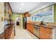 Charming kitchen featuring tile floor, wooden cabinetry, and granite countertops at 29049 Snapper Pt, Tega Cay, SC 29708