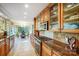 An elegant kitchen with glass front cabinets, tile floor, and a dining space at 29049 Snapper Pt, Tega Cay, SC 29708