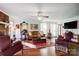 Bright living room featuring hardwood floors, a decorative fireplace, and comfortable seating at 29049 Snapper Pt, Tega Cay, SC 29708