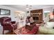 Cozy living room features a brick fireplace, hardwood floors, and an open view to the dining area at 29049 Snapper Pt, Tega Cay, SC 29708