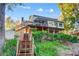 Back of house shows a multilevel wood deck overlooking a steep hill and a lake in the distance at 29049 Snapper Pt, Tega Cay, SC 29708